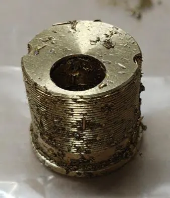 Brass lock plug with machining paste before cleaning